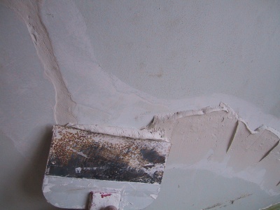 applying the 2nd coat to a crack repair in a plaster wall